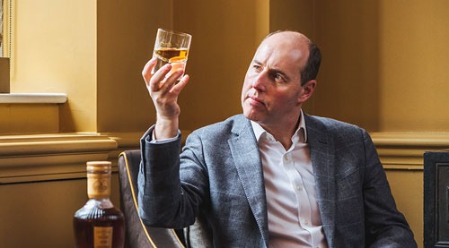 man holding a whisky
