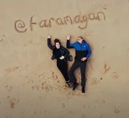 Two people lying on a beach