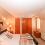 Bedroom with double bed and cupboards