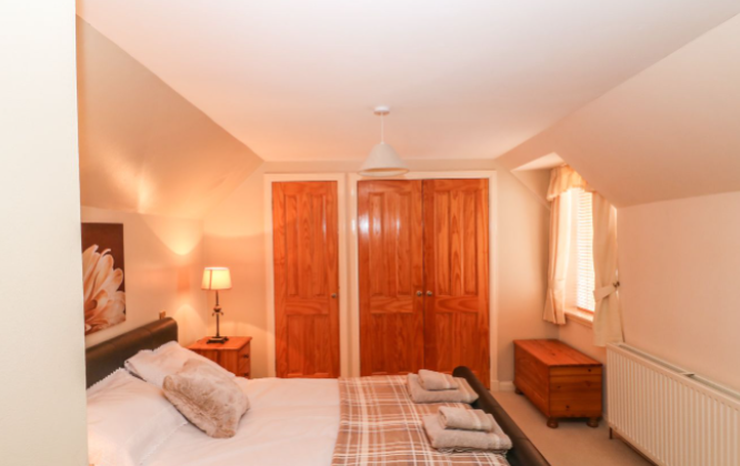 Bedroom with double bed and cupboards