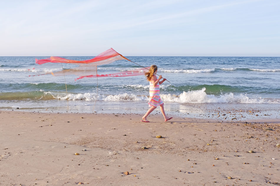 A girl walking along the beach