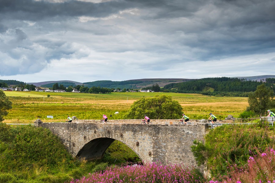 cyclists going across a bridge