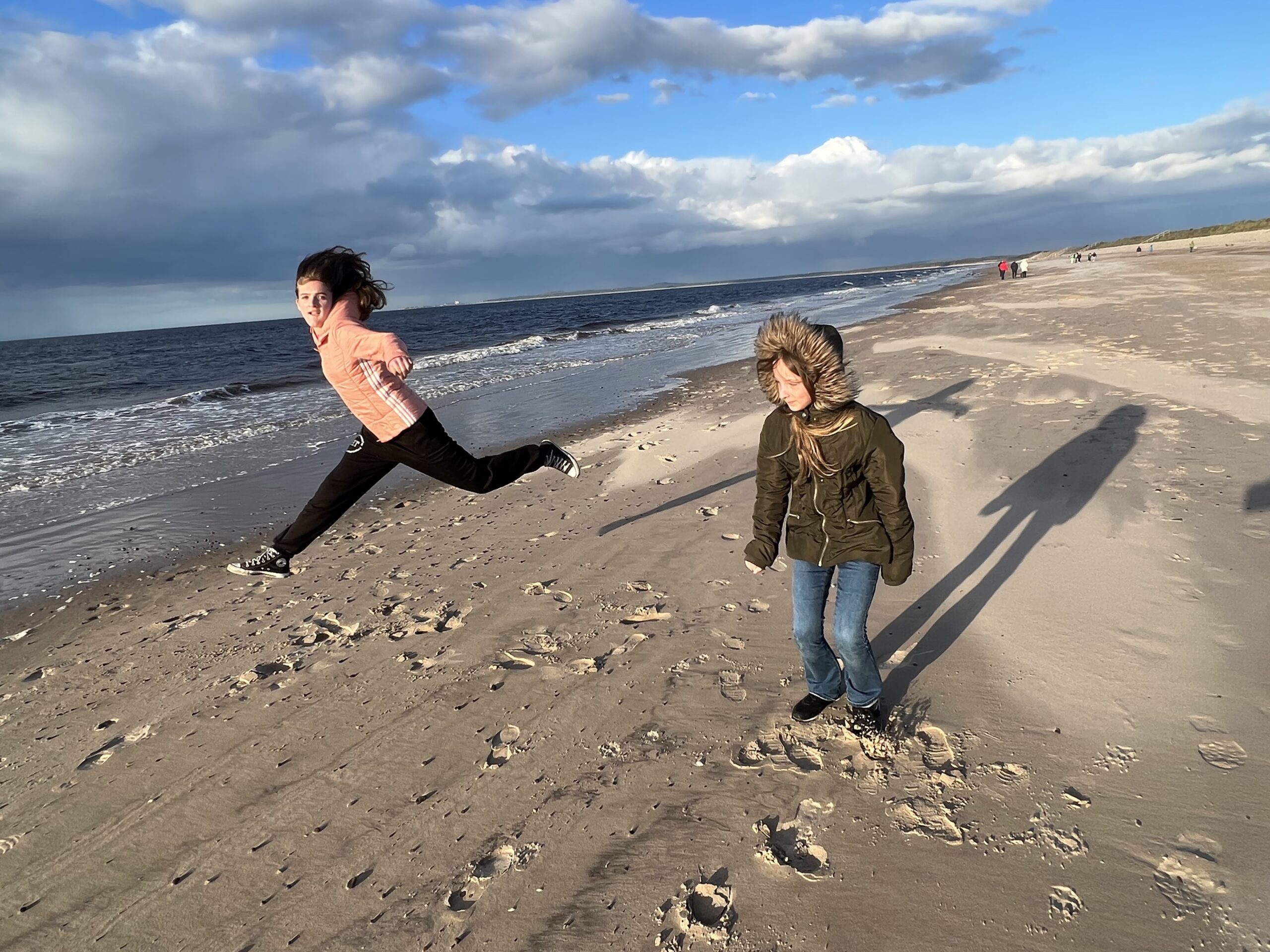 Two kids play on a beach