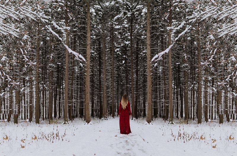 lady in red dress in snowy forest