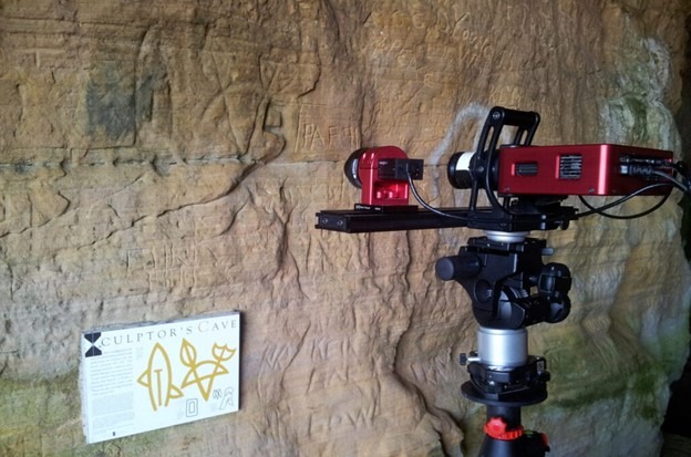 Laser mounted on a tripod pointed at cave wall