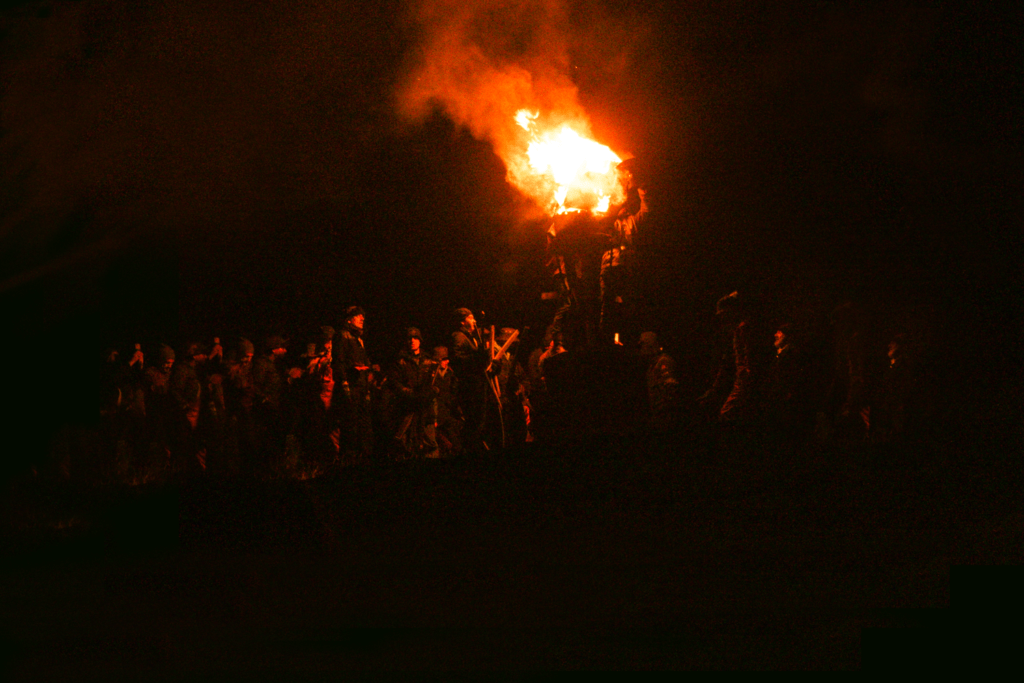 A crowd watch the burning of the clavie