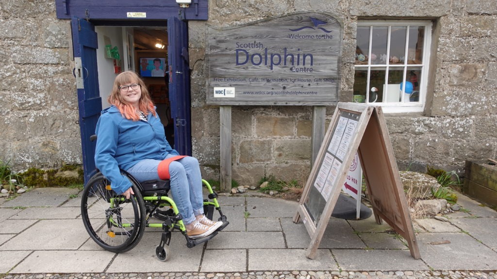 A lady in wheelchair outside WDC Dolphin Centre
