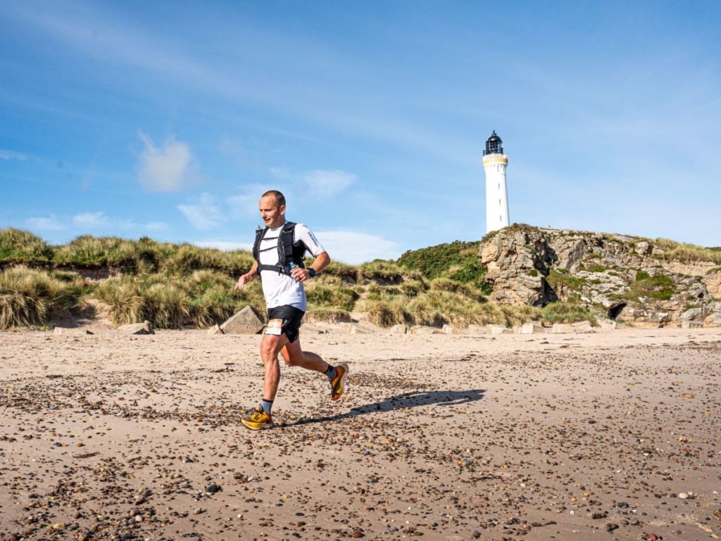 Runner runs past Covesea Lighthouse